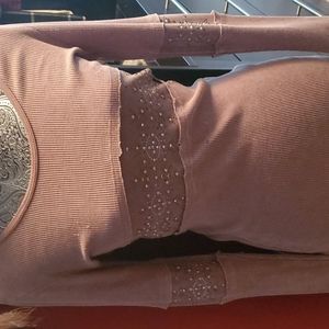 Cute top fitted with a bit of bling! Very flattering. Color is Mauve.